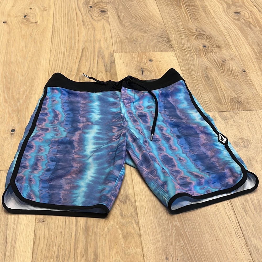Mens, blue, pink, green, and purple, size 28, Volcom swim trunks.